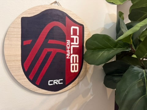 Hand-painted soccer crest sign reading Caleb Rohan